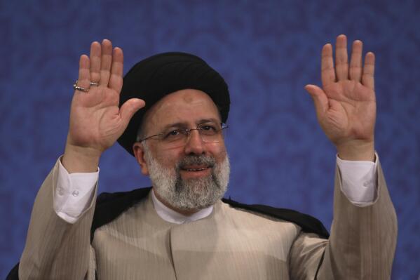 Iran's new President-elect Ebrahim Raisi waves to participants at the conclusion of his press conference in Tehran, Iran, Monday, June 21, 2021. Raisi said Monday he wouldn't meet with President Joe Biden nor negotiate over Tehran's ballistic missile program and its support of regional militias, sticking to a hard-line position following his landslide victory in last week's election. (AP Photo/Vahid Salemi)