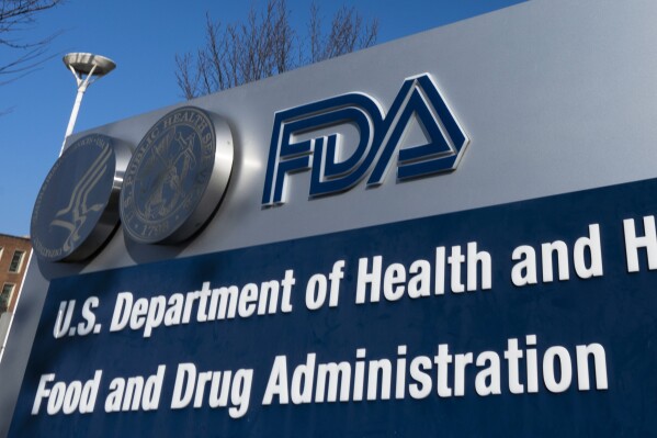 FILE - A sign for the U.S. Food and Drug Administration is displayed outside their offices, Dec. 10, 2020, in Silver Spring, Md. The FDA declined to approve a nasal spray to treat severe allergic reactions late Tuesday, Sept. 19, 2023, calling for more research on what would have been the first alternative to injections using devices such as an EpiPen. (AP Photo/Manuel Balce Ceneta, File)