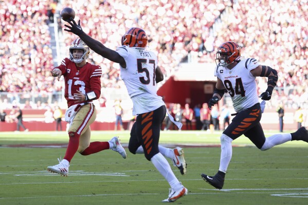 Cincinnati Bengals linebacker Germaine Pratt (57) reaches up to intercept a pass from San Francisco 49ers quarterback Brock Purdy (13) during the second half of an NFL football game in Santa Clara, Calif., Sunday, Oct. 29, 2023. (AP Photo/Jed Jacobsohn)