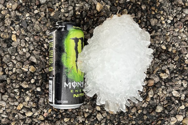 This photo provided by KWTV shows a hail stone, Sunday, June 2, 2024, near Vigo Park, Texas. The National Weather Service in Lubbock, Texas, said they believe the stone, which measured more than 7 inches long, is a new state record. (Val Castor/KWTV via AP)