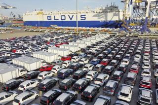 FILE - Cars and trucks for export are parked at a port in Yantai in eastern China's Shandong Province, Tuesday, Jan. 4, 2022. China’s monthly trade surplus soared to a record $97.9 billion in June as export growth accelerated following the easing of anti-virus controls that temporarily shut down Shanghai and disrupted trade. (Chinatopix via AP, File)