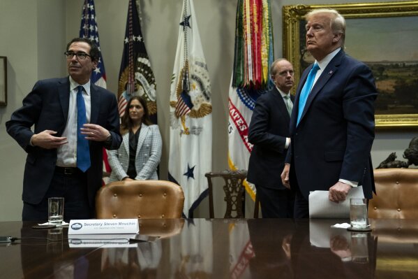 Treasury Secretary Steven Mnuchin and President Donald Trump listen to a question during a conference call with banks on efforts to help small businesses during the coronavirus pandemic, at the White House, Tuesday, April 7, 2020, in Washington. (AP Photo/Evan Vucci)