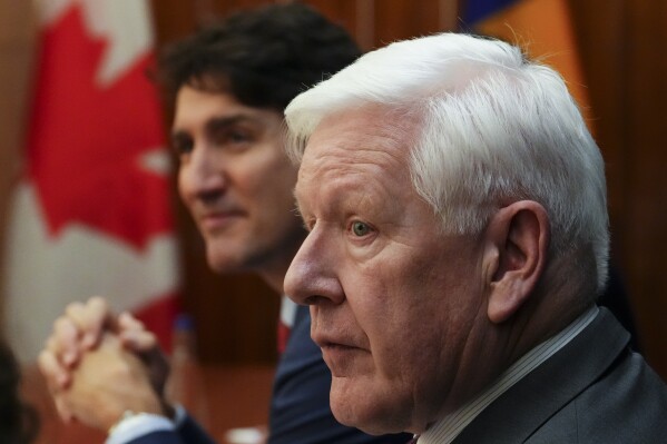 Canada's Prime Minister Justin Trudeau and Canadian Ambassador to the United Nations Bob Rae, right, take part in a bilateral with Prime Minister of Barbados Mia Mottley (not shown) during the Conference of Heads of Government of the Caribbean Community (CARICOM) in Nassau, Bahamas, Thursday, Feb. 16, 2023. (Sean Kilpatrick /The Canadian Press via AP, File)