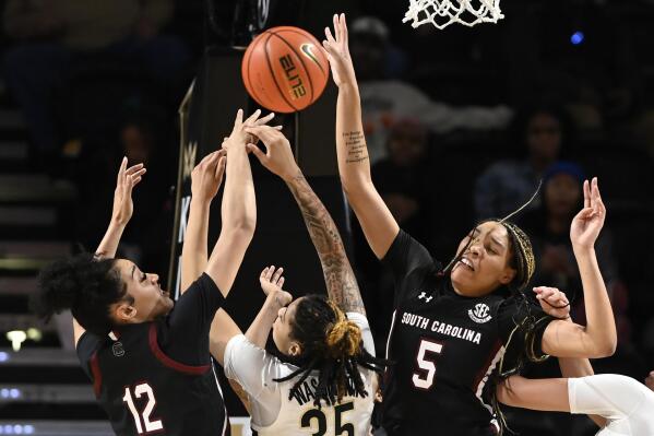 South Carolina guard Brea Beal (12) and forward Victaria Saxton (5) blocks a shot by Vanderbilt forward Sacha Washington (35) during the second half of an NCAA college basketball game Thursday, Jan. 19, 2023, in Nashville, Tenn. South Carolina won 96-48. (AP Photo/Mark Zaleski)