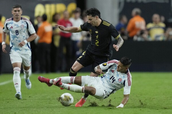 Costa Rica's Orlando Galo tackles Mexico's Jorge Sanchez during a CONCACAF Gold Cup soccer match Sunday, June 22, 2025, in Las Vegas. (AP Photo/John Locher)