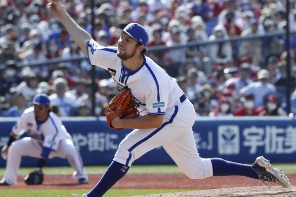 Yokohama DeNA BayStars pitcher Trevor Bauer delivers a pitch against Hiroshima Carp during baseball game in Yokohama, near Tokyo, Wednesday, May 3, 2023. After cheerleaders welcomed him, after receiving the largest ovation of any Yokohama player at the start of the game, Bauer delivered what was expected on Wednesday in his debut with the Yokohama DeNA Baystars.(Kyodo News via AP)