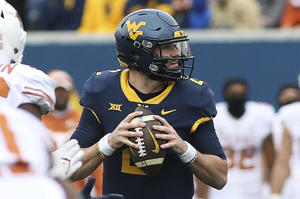 West Virginia quarterback Jarret Doege looks to pass against Texas during the first half of an NCAA college football game in Morgantown, W.Va., Saturday, Nov. 20, 2021. (AP Photo/Kathleen Batten)