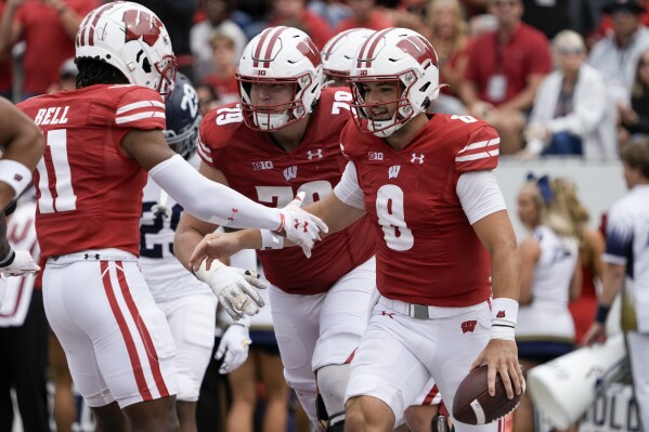 Wisconsin's Tanner Mordecai is congratulated after running for a touchdown during the second half of an NCAA college football game against Georgia Southern Saturday, Sept. 16, 2023, in Madison, Wis. (AP Photo/Morry Gash)