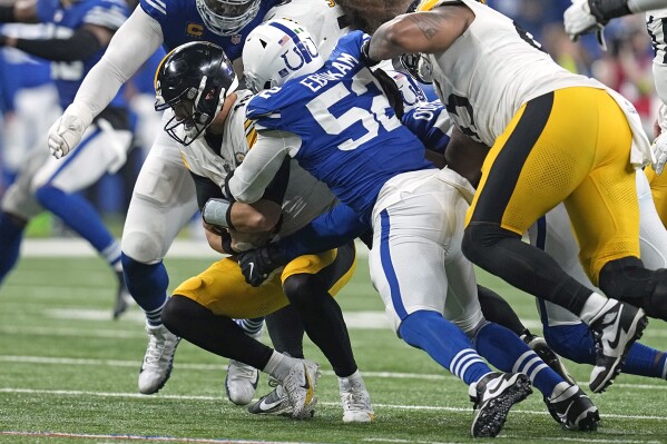 Pittsburgh Steelers quarterback Mitch Trubisky (10) is sacked by Indianapolis Colts defensive end Samson Ebukam (52) during the second half of an NFL football game in Indianapolis on Saturday, Dec. 16, 2023. (AP Photo/Darron Cummings)