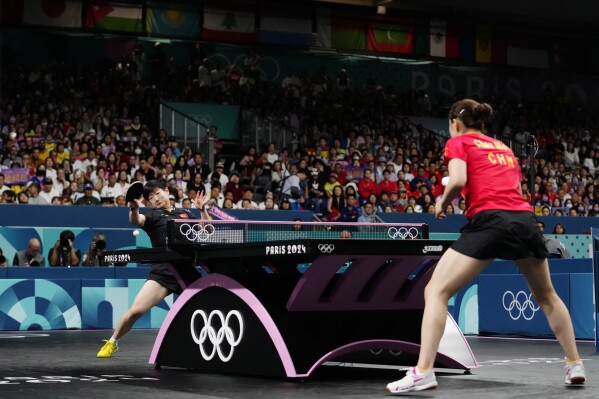 China's Sun Yingsha, background, plays against China's Chen Meng during the women's singles gold medal table tennis match at the 2024 Summer Olympics, Aug. 3, 2024, in Paris, France. (AP Photo/Petros Giannakouris, file)