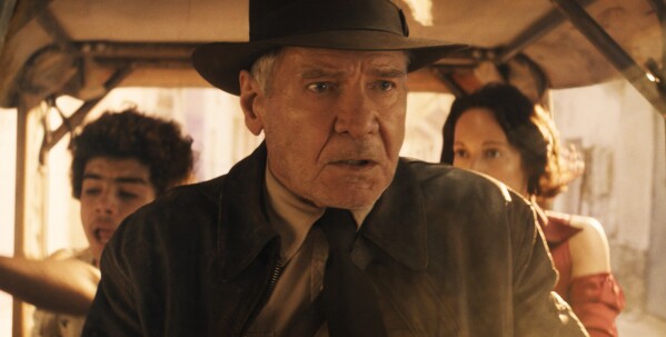 This image released by Lucasfilm shows Ethann Isidore, from left, Harrison Ford and Phoebe Waller-Bridge in a scene from "Indiana Jones and the Dial of Destiny." (Lucasfilm Ltd. via AP)