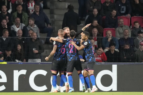 Sevilla players celebrate after Sevilla's Nemanja Gudelj scored his side's opening goal during the Group B Champions League soccer match between PSV and Sevilla at Philips stadium in Eindhoven, Netherlands, Tuesday, Oct. 3, 2023. (AP Photo/Peter Dejong)