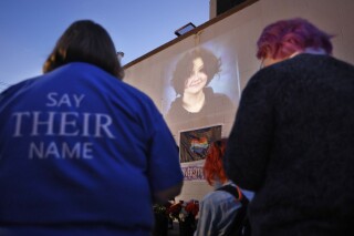 FILE - A photograph of Nex Benedict, a nonbinary teenager who died a day after a fight in a high school bathroom, is projected during a candlelight service at Point A Gallery, Saturday, Feb. 24, 2024, in Oklahoma City. Federal officials will investigate the Oklahoma school district where Benedict died, according to a letter sent by the U.S. Department of Education, Friday, March 1, 2024. (Nate Billings/The Oklahoman via AP, File)