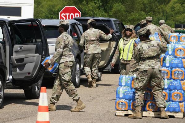 FILE - Members of the Mississippi National Guard distribute water and supplies to Jackson, Miss., residents, Sep. 2, 2022, in Jackson. Mississippi lawmakers advanced a bill Tuesday, Jan. 24, 2023, that would transfer ownership of the state capital city's troubled water system to a new public entity overseen by a nine-member board, the majority of whom would be appointed by state leaders. (AP Photo/Steve Helber, File)