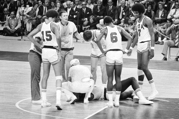 FILE - U.S. player James Brewer is checked after a hard fall during the team's men's basketball final against the Soviet Union at the Olympics in Munich, Sept. 10, 1972. Russia won 51-50. Members of the 1972 U.S. Olympic men's basketball team have talked about finally retrieving those silver medals they vowed to never accept and left behind in Germany. No, they still don't want them for themselves. They believe the medals belong in the Naismith Memorial Basketball Hall of Fame, but the latest attempt to get them from the International Olympic Committee has been thwarted. (AP Photo, File)