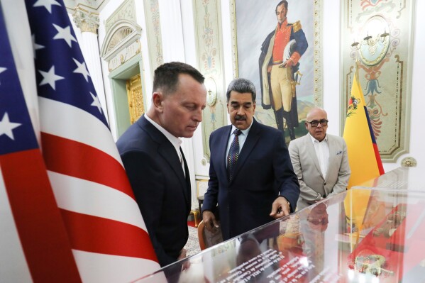 This photo released by Venezuela's presidential press office shows Venezuelan President Nicolas Maduro, center, with Richard Grenell, President Donald Trump's special envoy, left, accompanied by National AssemblyPresident Jorge Rodriguez, at Miraflores presidential palace in Caracas, Venezuela, Jan. 31, 2025. (Venezuela's presidential press office, via AP File)