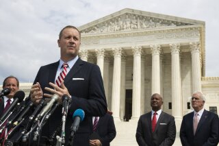 FILE - In this Sept. 9, 2019, file photo, Missouri Attorney General Eric Schmitt speaks in front of the U.S. Supreme Court in Washington. Schmitt on Tuesday, April 21, 2020, filed a lawsuit against the Chinese government, the Community Party of China and others, alleging that the hiding of information and other actions at the outset of the coronavirus outbreak led to loss of life and significant economic damage in Missouri. (AP Photo/Manuel Balce Ceneta, File)