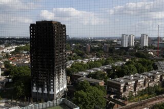 
              The remains of Grenfell Tower stand in London, Saturday, June 17, 2017. Police Commander Stuart Cundy said Saturday it will take weeks or longer to recover and identify all the dead in the public housing block that was devastated by a fire early Wednesday. (AP Photo/Kirsty Wigglesworth)
            