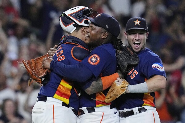 Houston Astros starting pitcher Framber Valdez, center, is embraced by catcher Martin Maldonado and third baseman Alex Bregman after throwing a no-hitter against the Cleveland Guardians, Tuesday, Aug. 1, 2023, in Houston. (AP Photo/Kevin M. Cox)