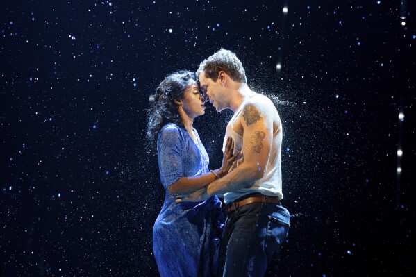 This image released by Boneau/Bryan-Brown shows Joy Woods, left, and Ryan Vasquez during a performance of "The Notebook" in New York, the new musical based on the bestselling novel by Nicholas Sparks that inspired the iconic film. (Julieta Cervantes/Boneau/Bryan-Brown via AP)