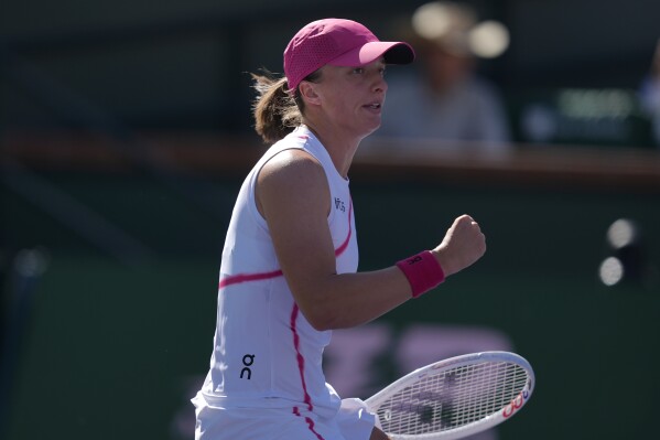 Iga Swiatek, of Poland, reacts during a match against Danielle Collins, of the United States, at the BNP Paribas Open tennis tournament in Indian Wells, Calif., Friday, March 8, 2024. (AP Photo/Ryan Sun)
