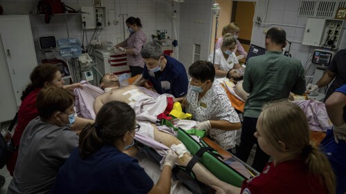 Medical staff move a seriously wounded Ukrainian serviceman at the ICU department of Mechnikov Hospital in Dnipro, Ukraine, Friday, July 14, 2023. A surge of wounded soldiers has coincided with the major counteroffensive Ukraine launched last month to try to recapture its land from Russian forces. Surgeons at the Mechnikov Hospital, one of the country's biggest, are busier now than perhaps at any other time since Russia began its invasion 17 months ago. (AP Photo/Evgeniy Maloletka)