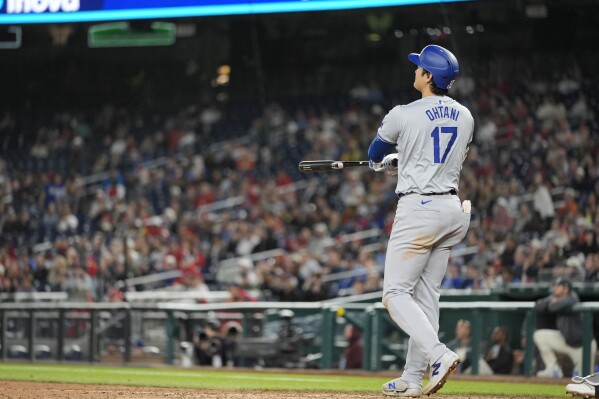 Los Angeles Dodgers designated hitter Shohei Ohtani watches his solo home run during the ninth inning of a baseball game against the Washington Nationals at Nationals Park, Tuesday, April 23, 2024, in Washington. The Dodgers won 4-1. (AP Photo/Alex Brandon)