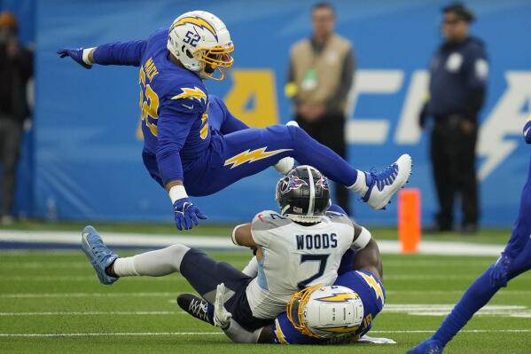 Tennessee Titans wide receiver Robert Woods (2) is tackled between Los Angeles Chargers linebacker Khalil Mack (52) and linebacker Kenneth Murray Jr. during the first half of an NFL football game in Inglewood, Calif., Sunday, Dec. 18, 2022. (AP Photo/Ashley Landis)