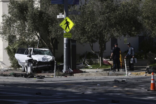 FILE - Authorities investigate after an SUV crashed into a bus stop March 16, 2024, in San Francisco. An infant whose parents and brother were killed in the crash has died, officials said Wednesday, March 20. Supervisor Myrna Melgar, who represents the area where crash occurred, confirmed the child's death, the San Francisco Chronicle reported. (Benjamin Fanjoy/San Francisco Chronicle via AP, File)