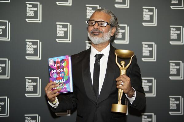 FILE - Author Shehan Karunatilaka holds the Booker Prize during a photo call after the announcement of his victory, at the Roundhouse in London, Monday, Oct. 17, 2022. (AP Photo/Alberto Pezzali, File)