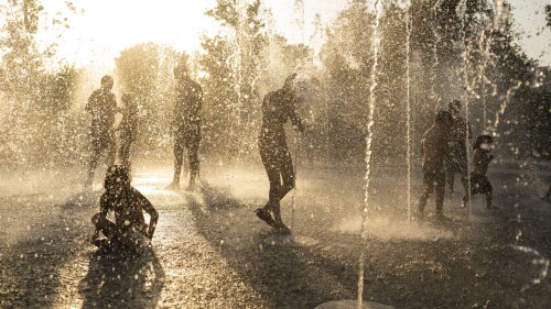 FILE - Children play with water at a fountain during a heat wave, at Stavros Niarchos foundation Cultural Center in Athens, July 21, 2023. A new study Tuesday, July 25, finds these intense and deadly hot spells gripping much of the globe in the American Southwest and Southern Europe could not have occurred without climate change. (AP Photo/Petros Giannakouris, File)