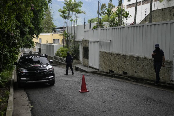 A police patrol car sits parked outside Argentina's embassy where some members of Venezuela's opposition are seeking asylum inside, in Caracas, Venezuela, July 31, 2024, three days after the contested presidential election. (AP Photo/Matias Delacroix, File)