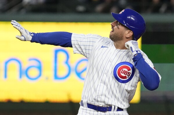 Chicago Cubs' Mike Tauchman celebrates his RBI double against the Washington Nationals during the fourth inning of a baseball game in Chicago, Wednesday, July 19, 2023. (AP Photo/Nam Y. Huh)