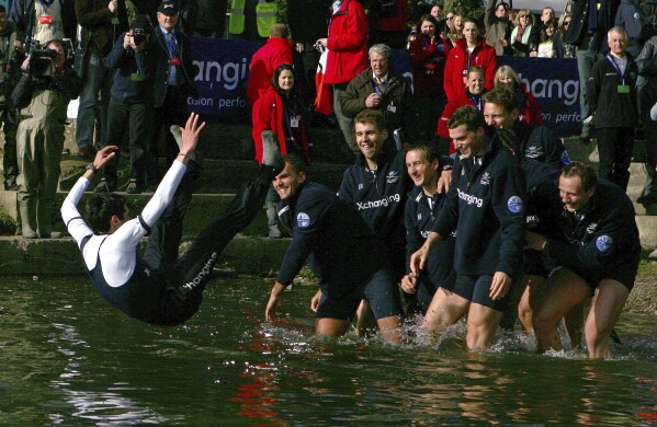 FILE - The Oxford crew, right, throw their cox Colin Groshong into the Thames at the 155th Boat Race, in London, Sunday March 29, 2009. Jumping into London’s River Thames has been the customary celebration for members of the winning crew in the annual Boat Race between storied English universities Oxford and Cambridge. Now researchers say it comes with a health warning. (AP Photo/Tom Hevezi, File)