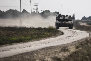 
              An Israeli tank drives near the Israel Gaza border, Tuesday, Nov. 13, 2018. (AP Photo/Tsafrir Abayov)
            