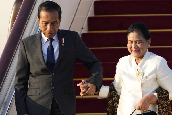 Indonesian President Joko Widodo, left, arrives at Beijing Capital International Airport to attend the third Belt and Road Forum in Beijing, China, Monday, Oct. 16, 2023. (Ken Ishii/Pool Photo via AP)