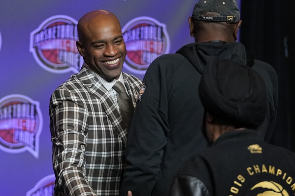 Vince Carter greets guest before the Basketball Hall of Fame news conference Friday, Feb. 16, 2024, in Indianapolis. (APPhoto/Darron Cummings)