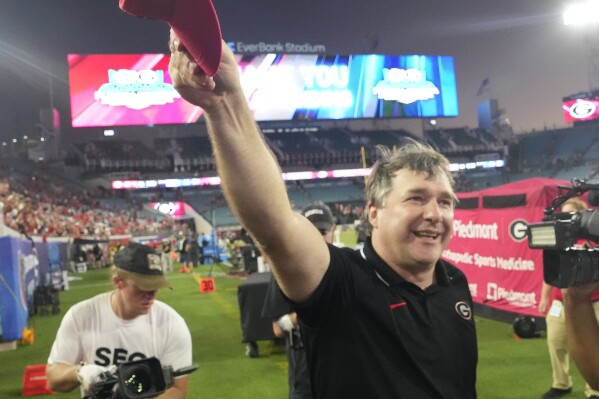 Georgia head coach Kirby Smart celebrates in front of fans as he runs off the field after defeating Florida in an NCAA college football game, Saturday, Oct. 28, 2023, in Jacksonville, Fla. (AP Photo/John Raoux)