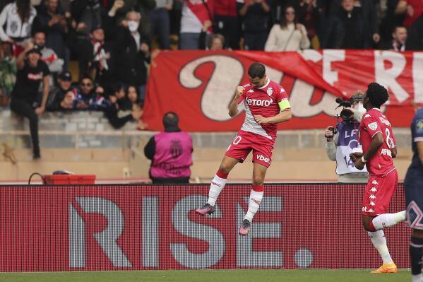 Monaco's Wissam Ben Yedder, left, celebrates after scoring his side's 3rd goal on a penalty kick during the French League One soccer match between Monaco and Paris Saint-Germain at the Stade Louis II in Monaco, Sunday, March 20, 2022. (AP Photo/Daniel Cole)