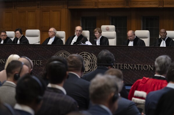 Presiding judge Joan Donoghue, third from right, reads the United Nations top court's ruling in The Hague, Netherlands, Wednesday, Jan. 31, 2024, in a case in which Ukraine accuses Russia of bankrolling rebels in 2014 and discriminating against Crimea's multiethnic community since its annexation of the region. It is the first of two decisions by the International Court of Justice linked to the decade-long conflict between Russia and Ukraine that exploded into a full-blown war nearly two years ago. (AP Photo/Peter Dejong)
