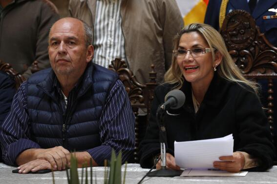 FILE - Accompanied by Interior Minister Arturo Murillo, Bolivia's interim President Jeanine Añez speaks during a press conference at the presidential palace, in La Paz, Bolivia, Nov. 23, 2019. According to a US Department of Justice statement on Wednesday, May 26, 2021, The former Bolivian interior minister was sentenced to nearly six years in U.S. prison Wednesday, Jan. 4, 2023, for taking at least $532,000 in bribes to help a Florida company win a lucrative contract to sell tear gas to his country's government. (AP Photo/Juan Karita, File)