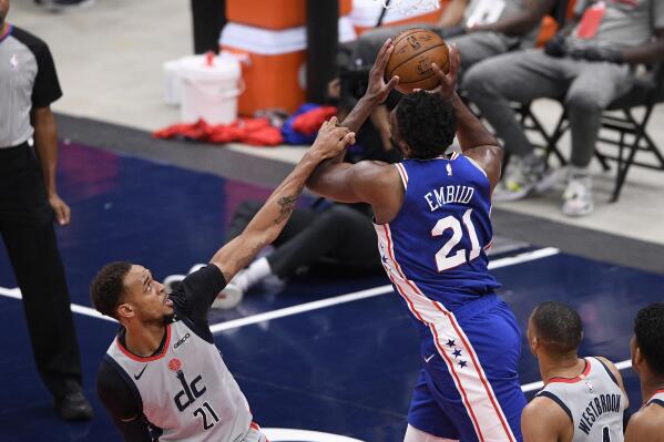 Philadelphia 76ers center Joel Embiid, right, is fouled by Washington Wizards center Daniel Gafford, left, during the first half of Game 4 in a first-round NBA basketball playoff series, Monday, May 31, 2021, in Washington. (AP Photo/Nick Wass)