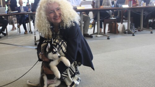 UConn president Radenka Maric holds the schools new mascot, Jonathan XV during a board of trustees meeting on Wednesday, June 28, 2023, in Storrs, Conn. The puppy is living with the same host family as UConn's current mascot, Jonathan XIV, and being trained for his new duties, which include appearing at sporting and other on-campus events and doing social media promotions. (AP Photo/Pat Eaton-Robb)