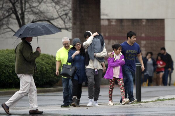 
              People exit the Dalton Convention Center on Wednesday, Feb. 28, 2018 in Dalton, Ga. Students from Dalton High School were evacuated to the Dalton Convention Center after social studies teacher Randal Davidson allegedly barricaded himself in a classroom and fired a handgun. (C.B. Schmelter/Chattanooga Times Free Press via AP)
            
