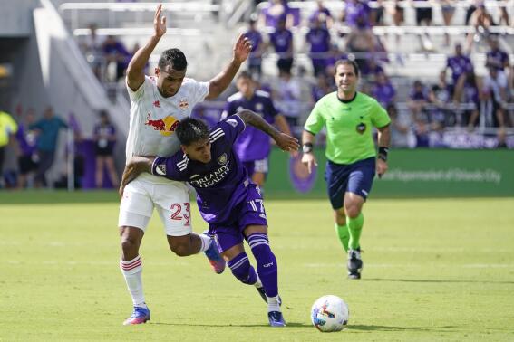 Orlando City forward Facundo Torres (17) gets position on the ball in front of New York Red Bulls midfielder Cristian Casseres Jr (23) during the first half of an MLS soccer match, Sunday, April 24, 2022, in Orlando, Fla. (AP Photo/John Raoux)