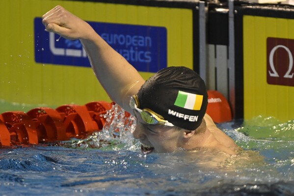 Ireland's Daniel Wiffen celebrates after winning the Men's 800m Freestyle final at the LEN European Short Course Swimming Championships in Otopeni, Romania, Sunday, Dec. 10, 2023. (AP Photo/Alexandru Dobre)