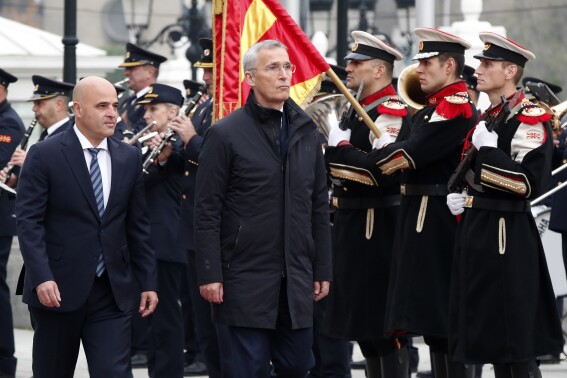 NATO Secretary General Jens Stoltenberg, center, accompanied by North Macedonia's Prime Minister Dimitar Kovacevski, left, review the honor guard squad at the Government building in Skopje, North Macedonia, on Tuesday, Nov. 21, 2023. NATO Secretary General arrived Tuesday on a two-day visit to North Macedonia as a part of his Western Balkans tour. (AP Photo/Boris Grdanoski)