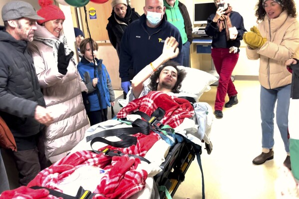 This screengrab from video provided by Rich Price shows Hisham Awartani, who is paralyzed from the chest down after being shot in Burlington, Vt., leaving the University of Vermont Medical Center, Wednesday, Dec. 6, 2023, in Burlington, Vt. Awartani and his two childhood friends, all U.S. college students of Palestinian descent, were shot and seriously injured while walking on a street near the University of Vermont on Saturday, Nov. 25. (Rich Price via AP)