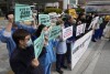 Members of The Korean Public Service and Transport Workers' Union stage a rally to demand expansion of public hospitals and medical students at the Seoul National University Hospital in Seoul, South Korea, Tuesday, Feb. 27, 2024. (AP Photo/Ahn Young-joon)