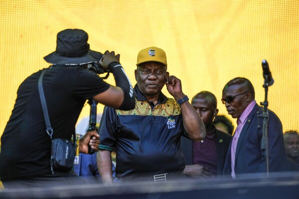 South African President Cyril Ramaphosa greets African National Congress supporters at the Siyanqoba rally at FNB stadium in Johannesburg, South Africa, Saturday, May 25, 2024. South African will vote in the 2024 general elections May 29. (AP Photo/Jerome Delay)